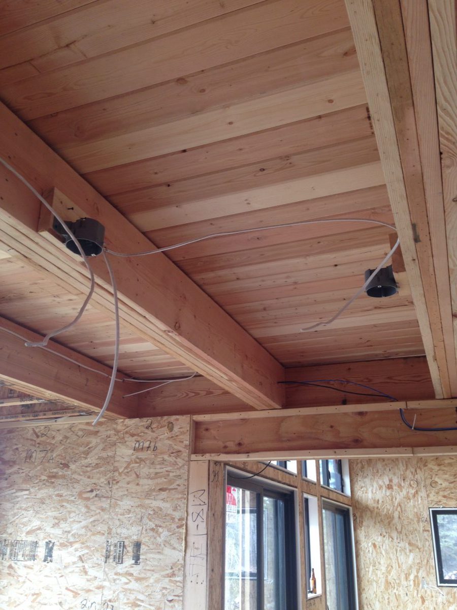 Fir tongue-and-groove floor for the loft creates an interesting ceiling from the kitchen and dining rooms.